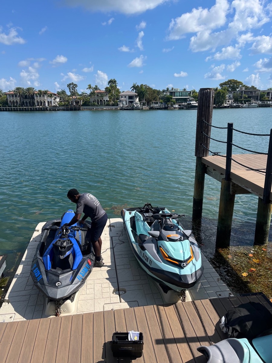 Technician servicing Sea-Doos at a client's dock