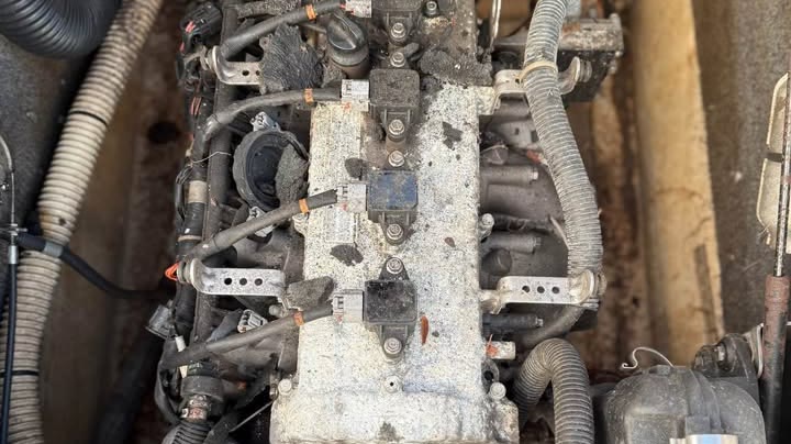 A neglected jet ski engine bay covered in corrosion and grime